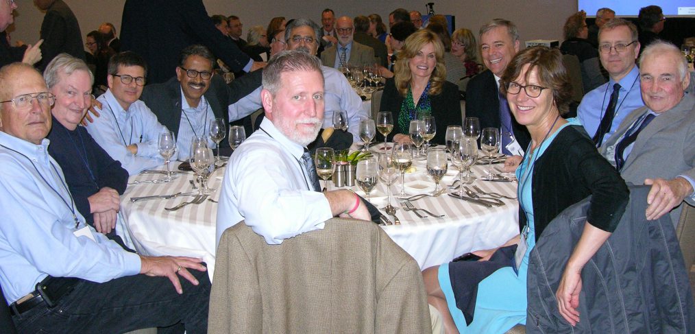 John Till (right) and Helen Grogan (2nd from right at front) at the Members' Dinner during the 2019 NCRP annual meeting
